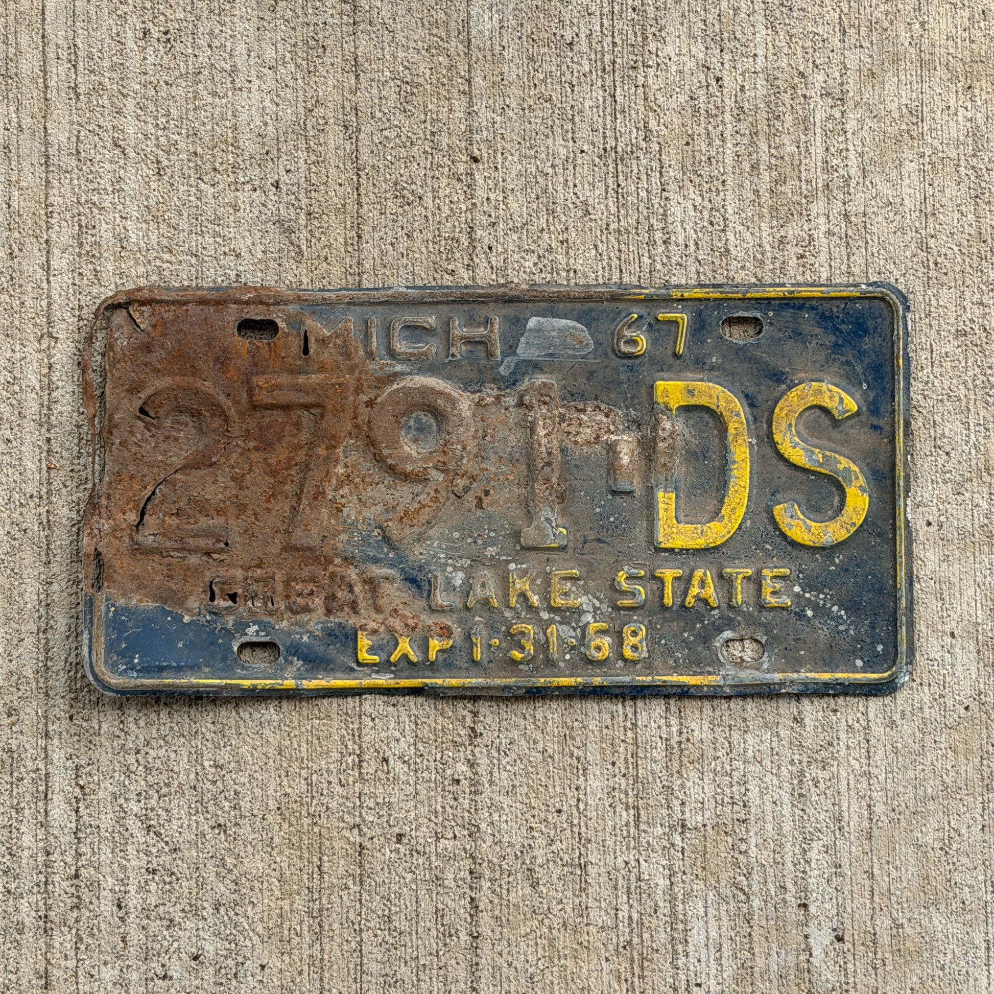 Photo of a 1967 Michigan Commercial License Plate Auto Tag Garage Decor Vintage 2791 DS with original patina