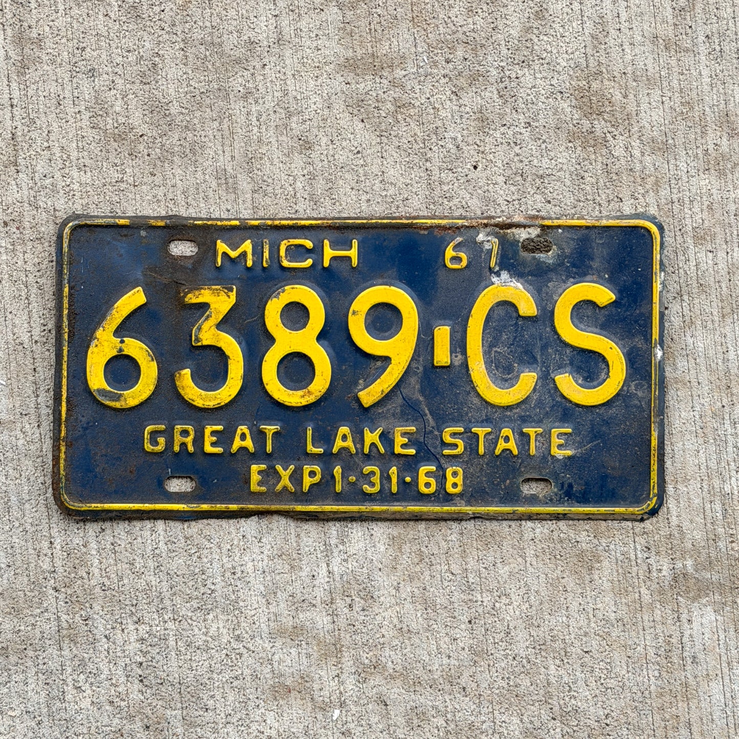 Photo of a 1967 Michigan Commercial License Plate Auto Tag Garage Decor Vintage 6389 CS with original patina