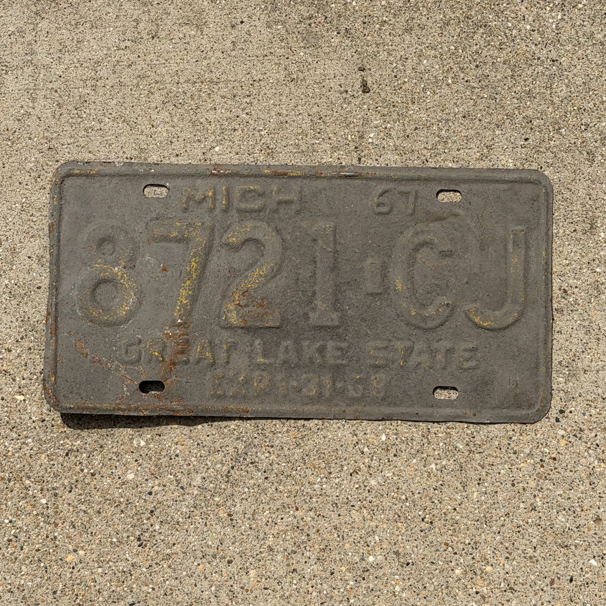 Photo of a 1967 Michigan Commercial License Plate Auto Tag Garage Decor Vintage 8721 CJ with original patina