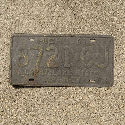 Photo of a 1967 Michigan Commercial License Plate Auto Tag Garage Decor Vintage 8721 CJ with original patina