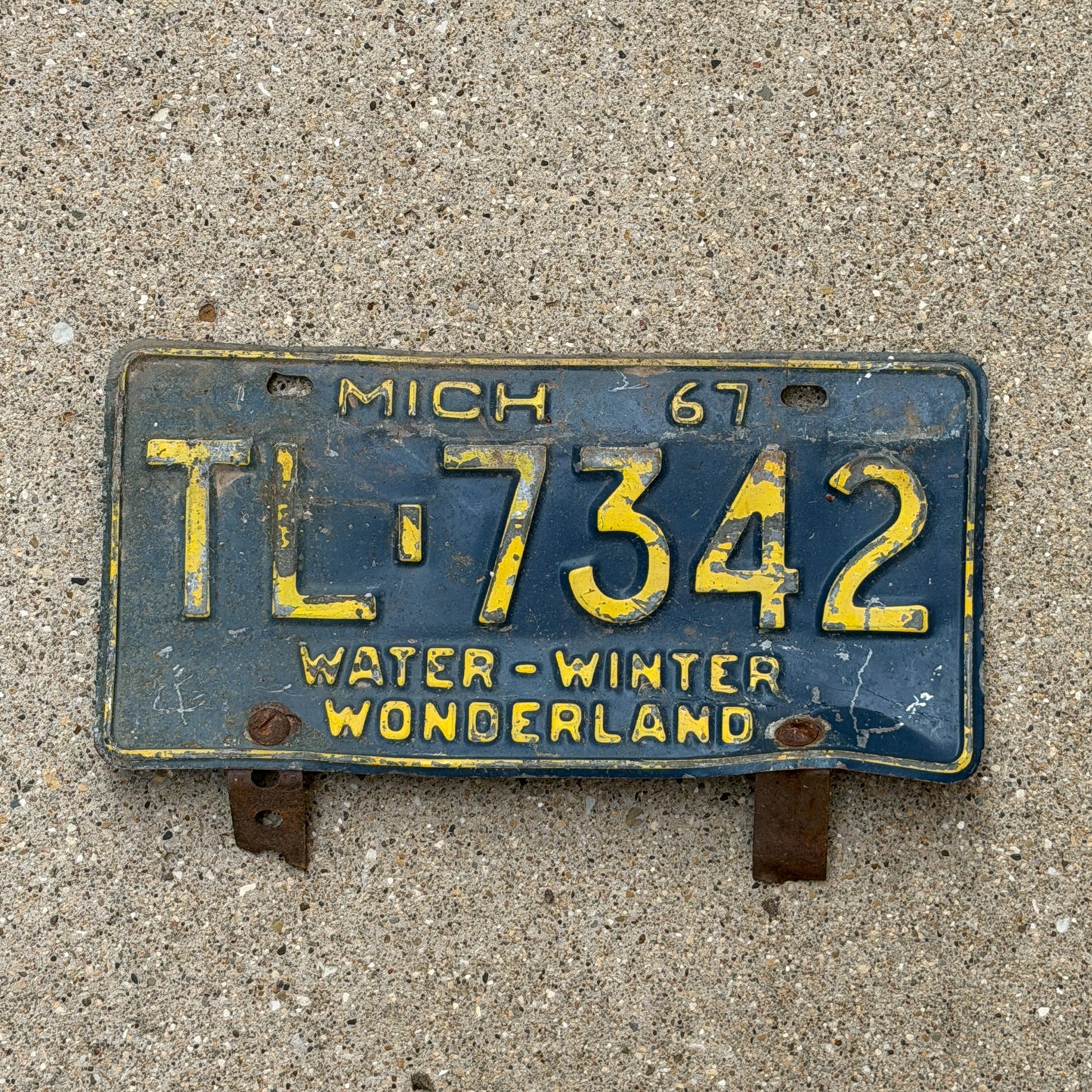 Photo of a 1967 Michigan License Plate Auto Tag 1 Vintage Garage TL 7342 with original patina