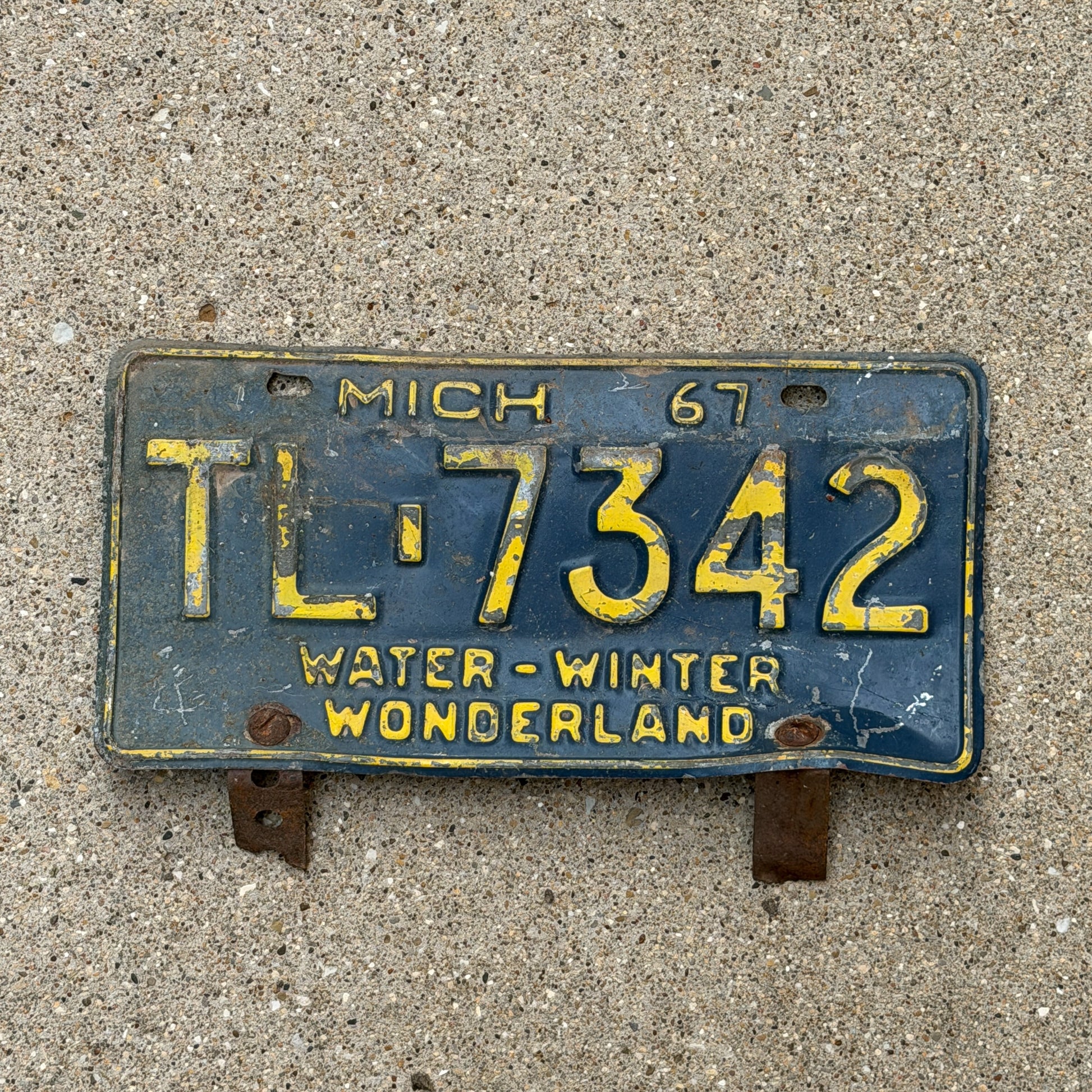 Photo of a 1967 Michigan License Plate Auto Tag 1 Vintage Garage TL 7342 with original patina