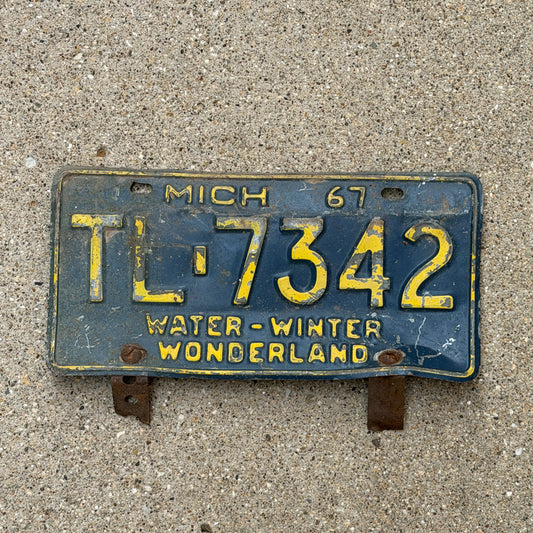 Photo of a 1967 Michigan License Plate Auto Tag 1 Vintage Garage TL 7342 with original patina