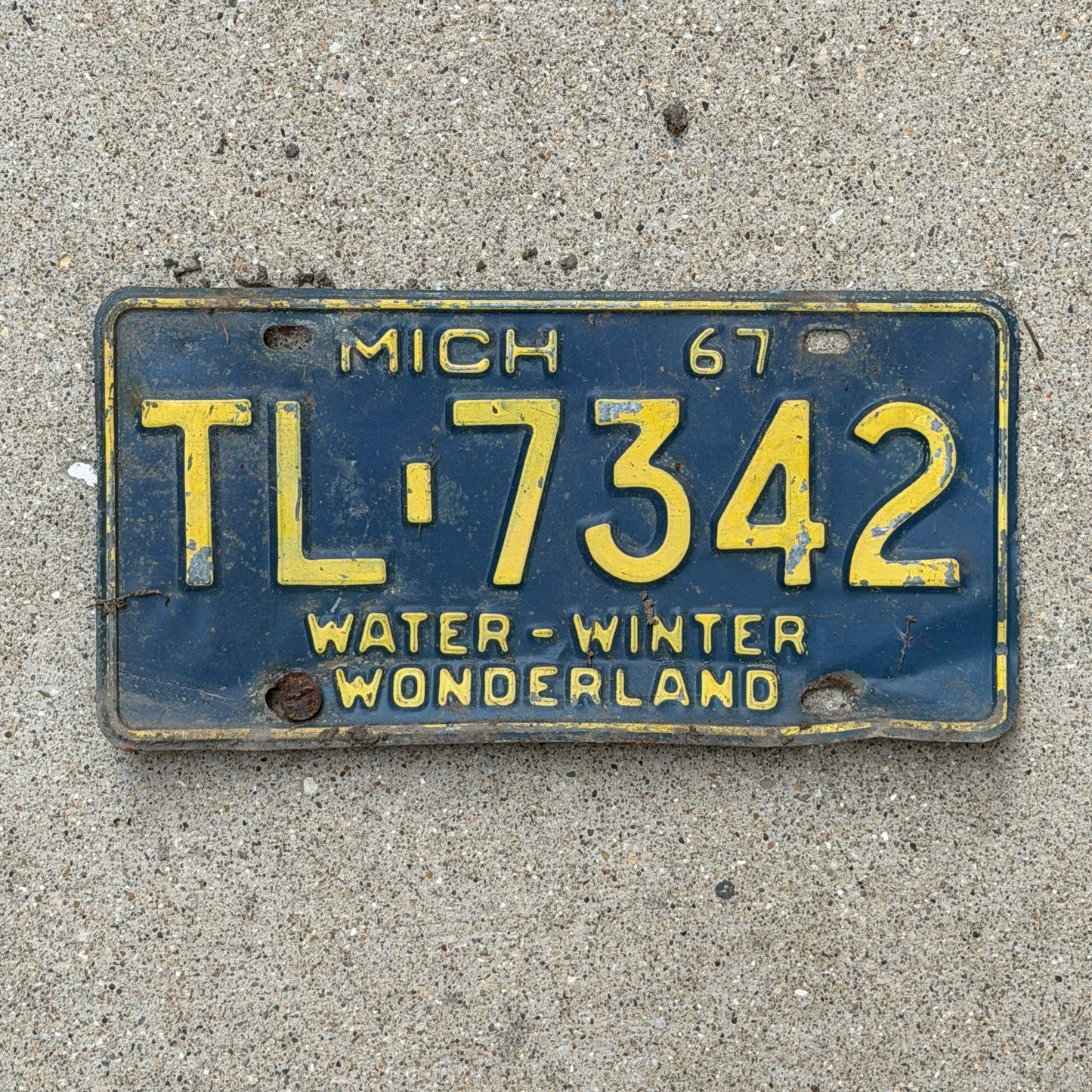 Photo of a 1967 Michigan License Plate Auto Tag 2 Vintage Garage TL 7342 with original patina