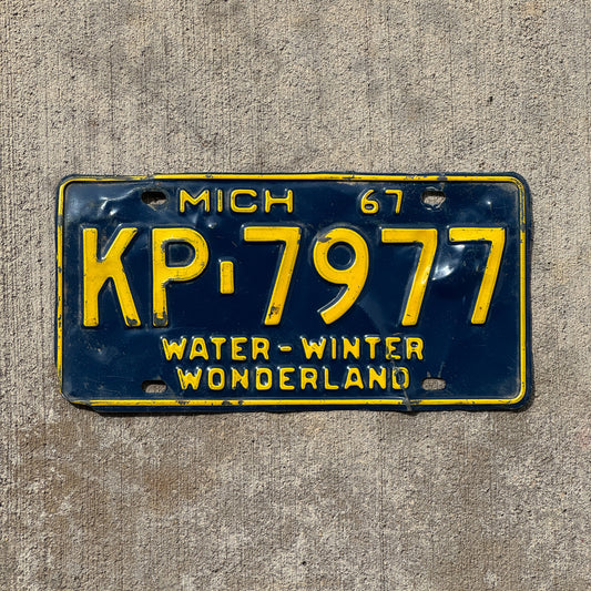 Photo of a 1967 Michigan License Plate Auto Tag Garage Decor Vintage KP 7977 with original patina