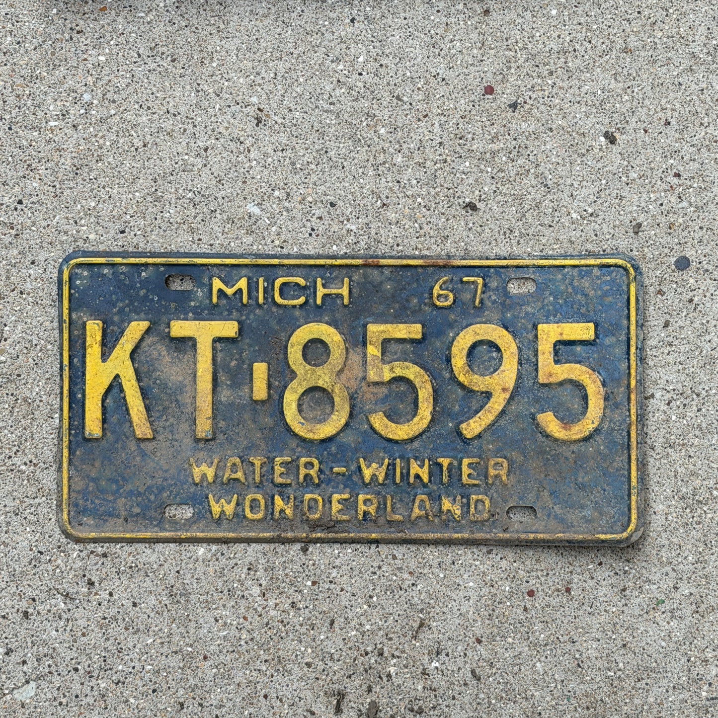 Photo of a 1967 Michigan License Plate Auto Tag Garage Decor Vintage KT 8595 with original patina
