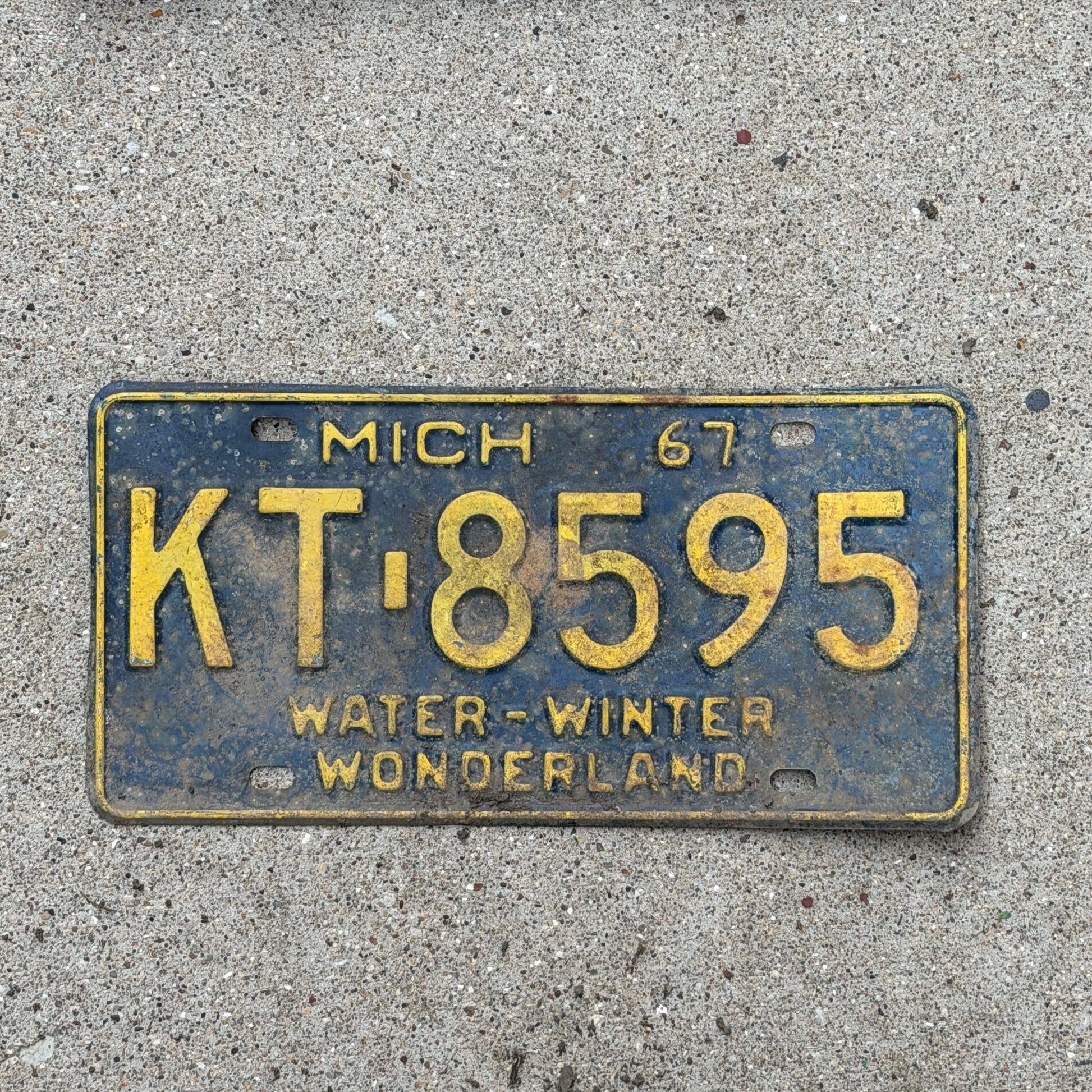 Photo of a 1967 Michigan License Plate Auto Tag Garage Decor Vintage KT 8595 with original patina