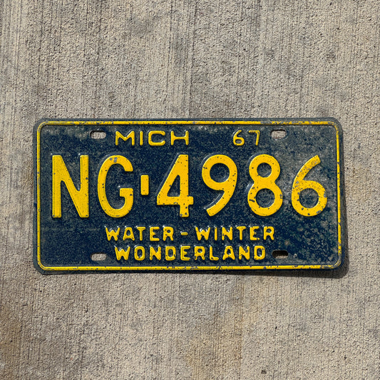 Photo of a 1967 Michigan License Plate Auto Tag Garage Decor Vintage NG 4986 with original patina