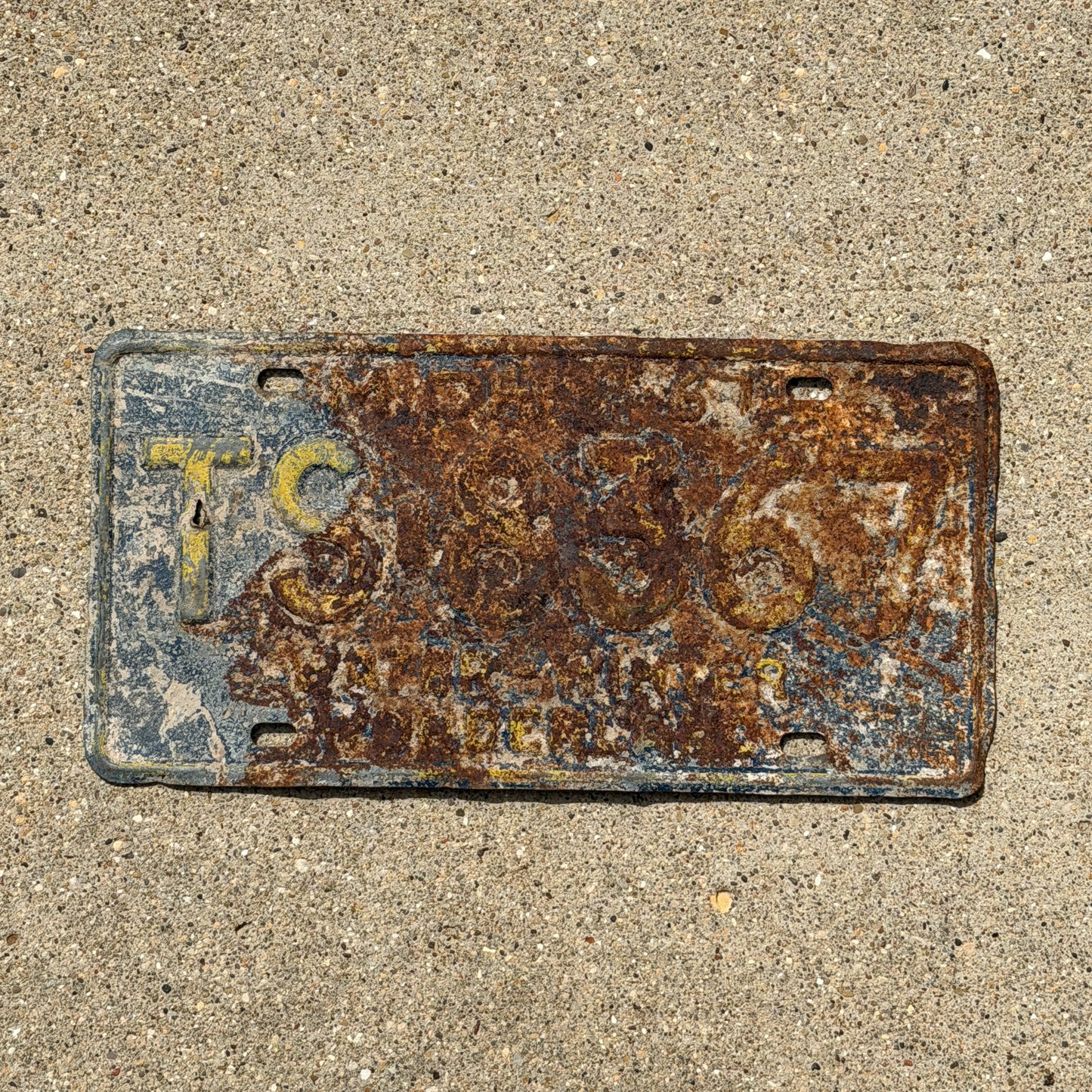 Photo of a 1967 Michigan License Plate Auto Tag Garage Decor Vintage TS 8367 with original patina