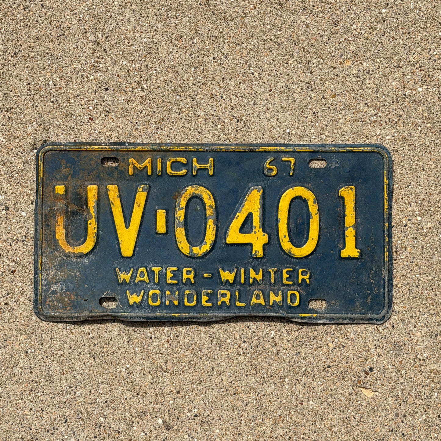 Photo of a 1967 Michigan License Plate Auto Tag Garage Decor Vintage UV 0401 with original patina