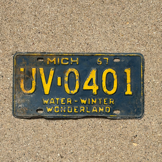 Photo of a 1967 Michigan License Plate Auto Tag Garage Decor Vintage UV 0401 with original patina