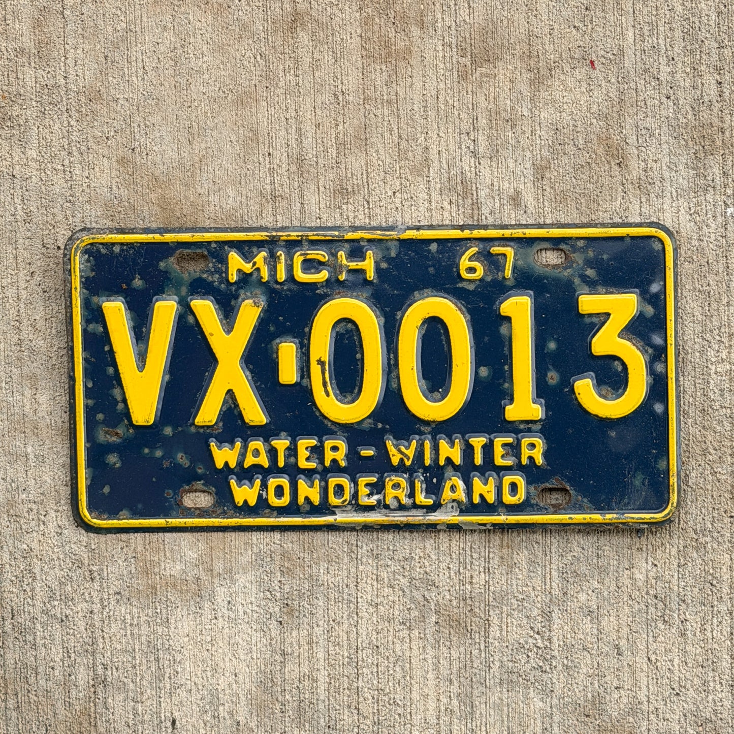 Photo of a 1967 Michigan License Plate Auto Tag Garage Decor Vintage VX 0013 with original patina