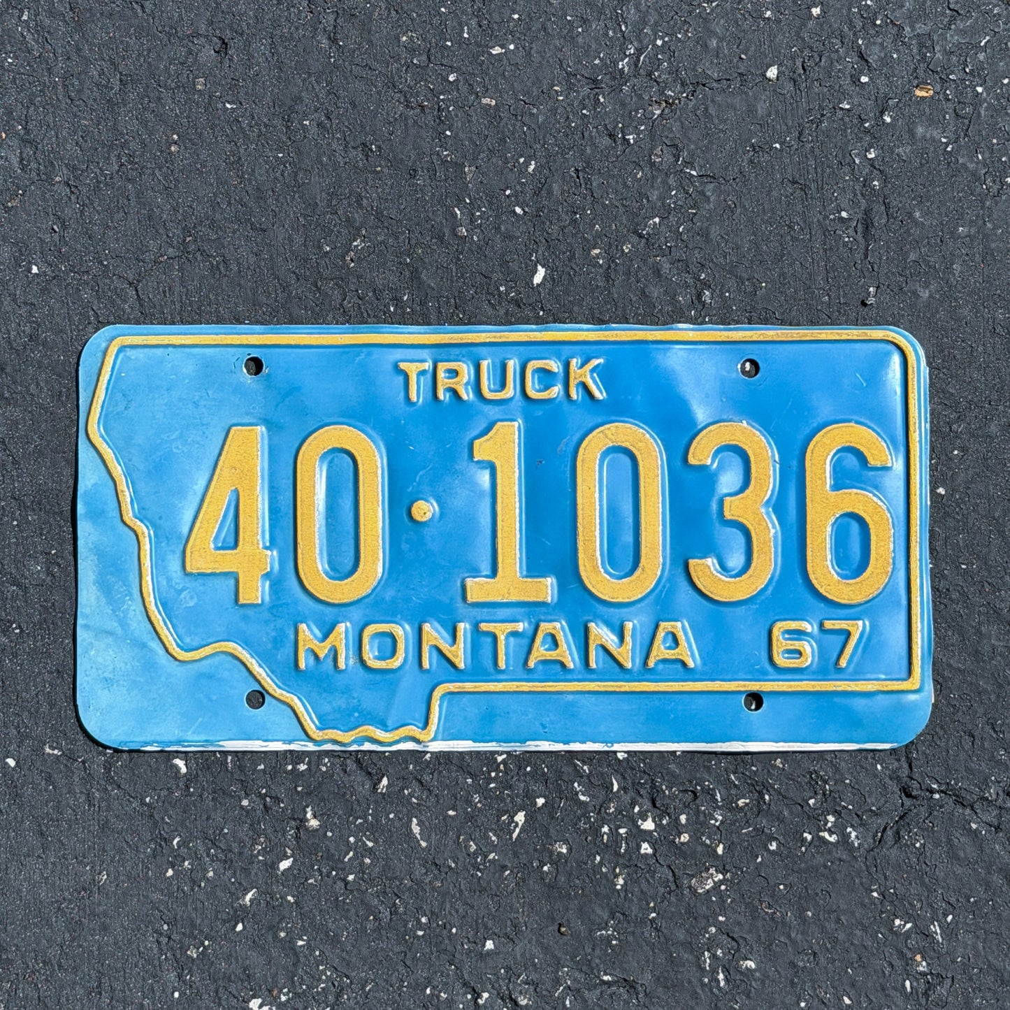 Photo of a 1967 Montana Truck License Plate Auto Tag Garage Decor Vintage State Shape 40 1036 with original patina