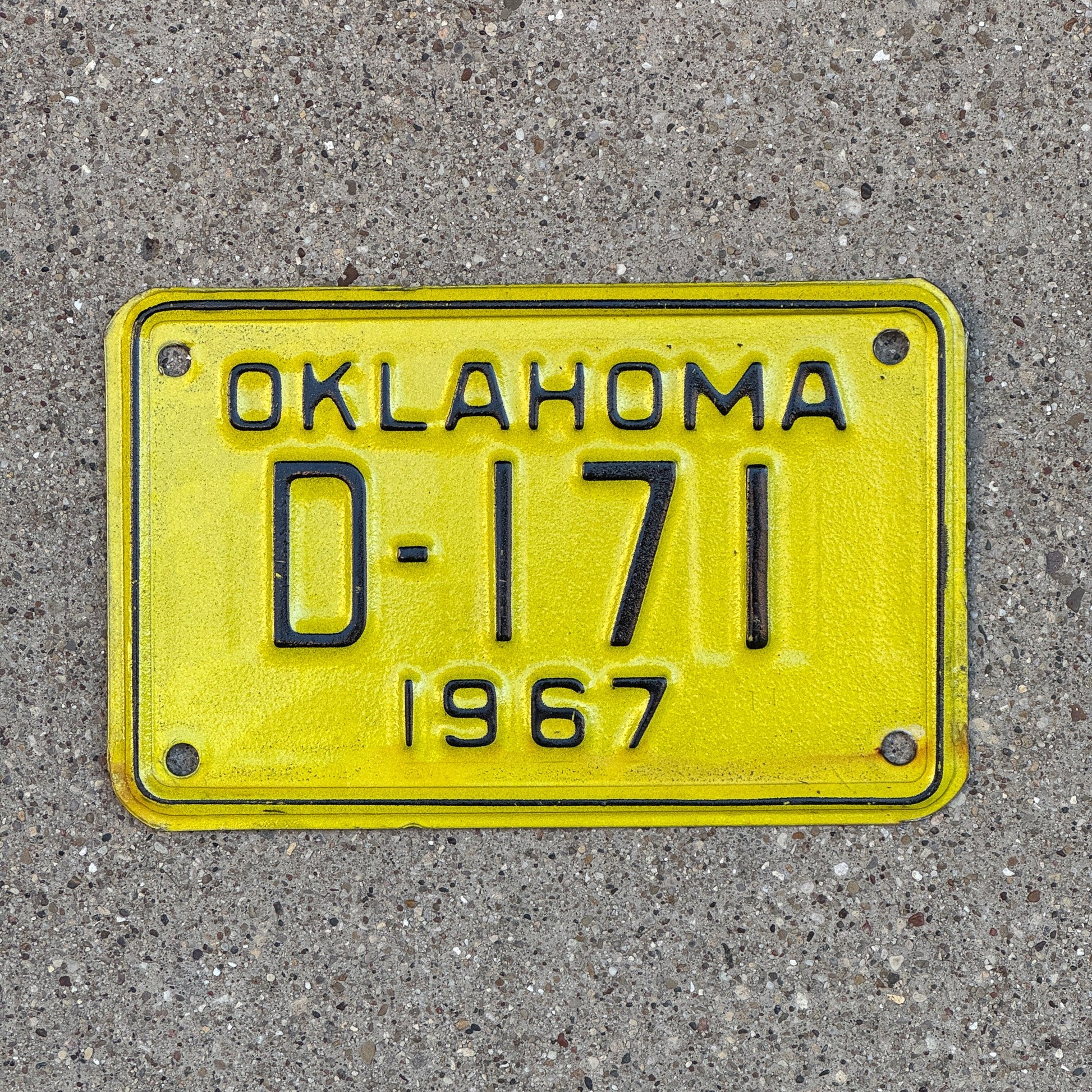 Photo of a 1967 Oklahoma Motorcycle Dealer License Plate Auto Tag Garage Decor Vintage D 171 with original patina