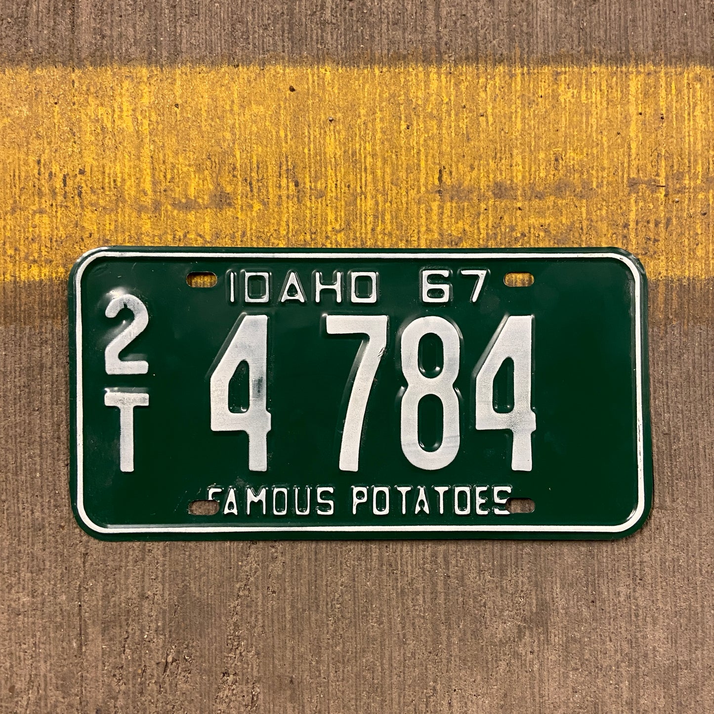Vintage Idaho license plate from 1967 on a concrete background