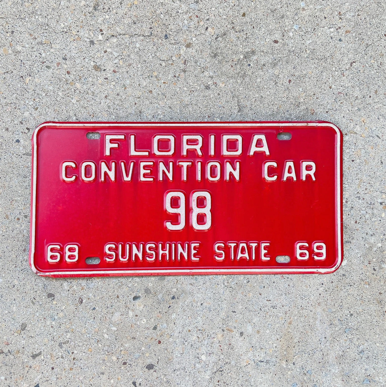 Photo of a 1968 1969 Florida Convention Car License Plate Auto Tag Garage Decor Vintage Low Number Two Digit 98 with original patina