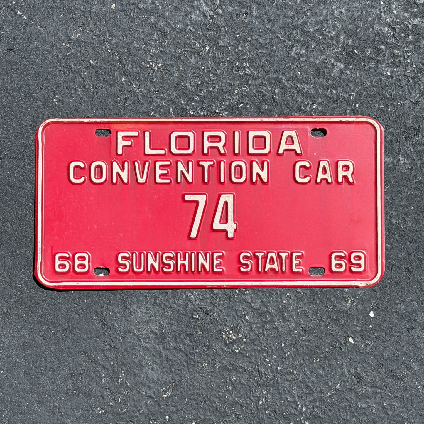 Photo of a 1968 Florida Convention Car License Plate Auto Tag Garage Decor Vintage 74 with original patina