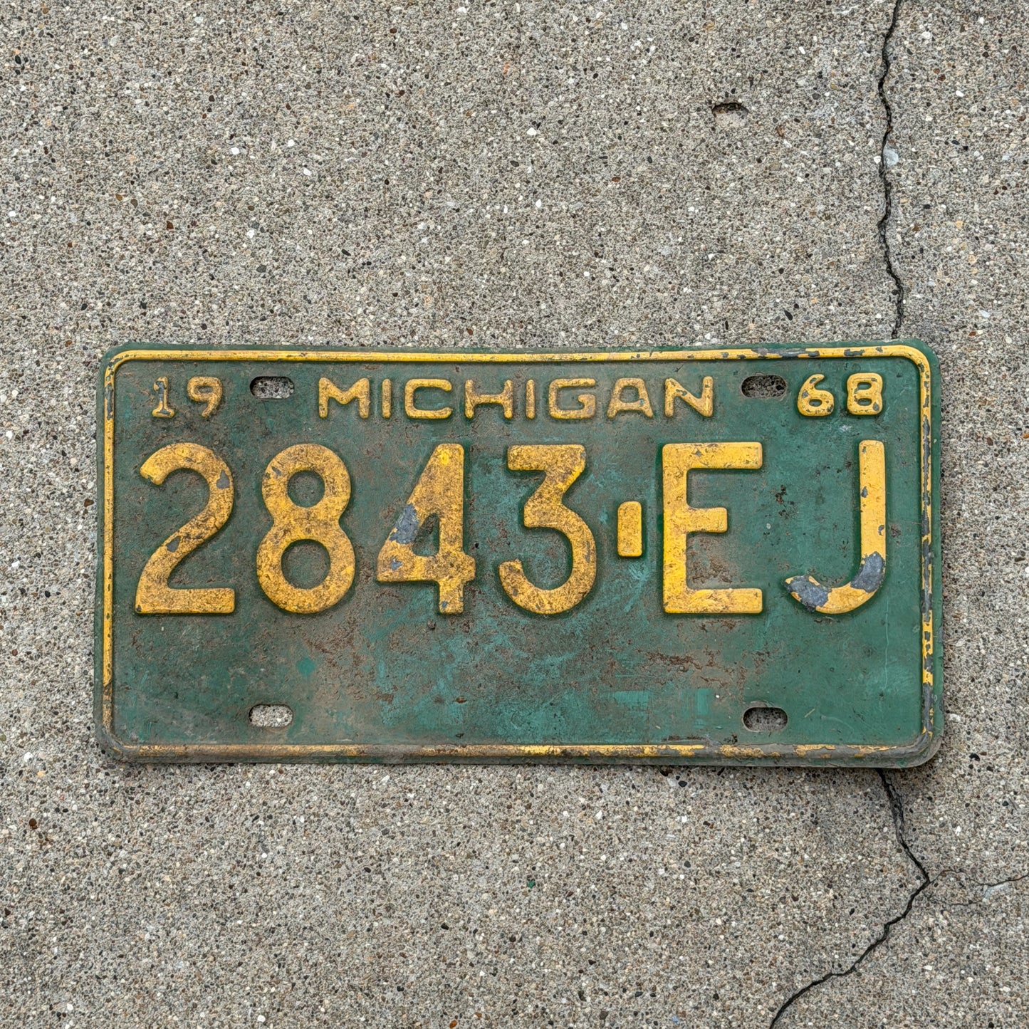 Photo of a 1968 Michigan Commercial License Plate Auto Tag Garage Decor Vintage 2843 EJ with original patina