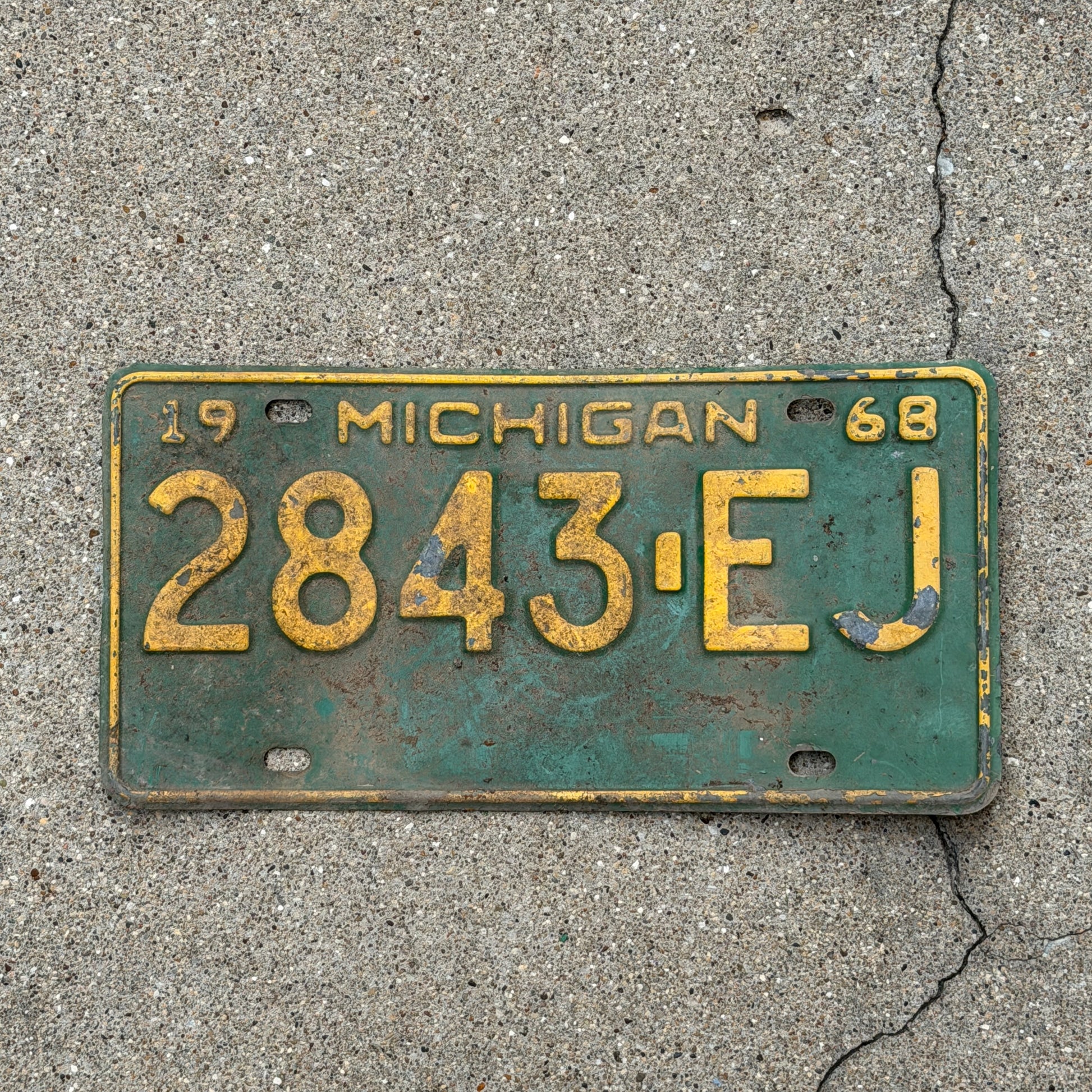 Photo of a 1968 Michigan Commercial License Plate Auto Tag Garage Decor Vintage 2843 EJ with original patina