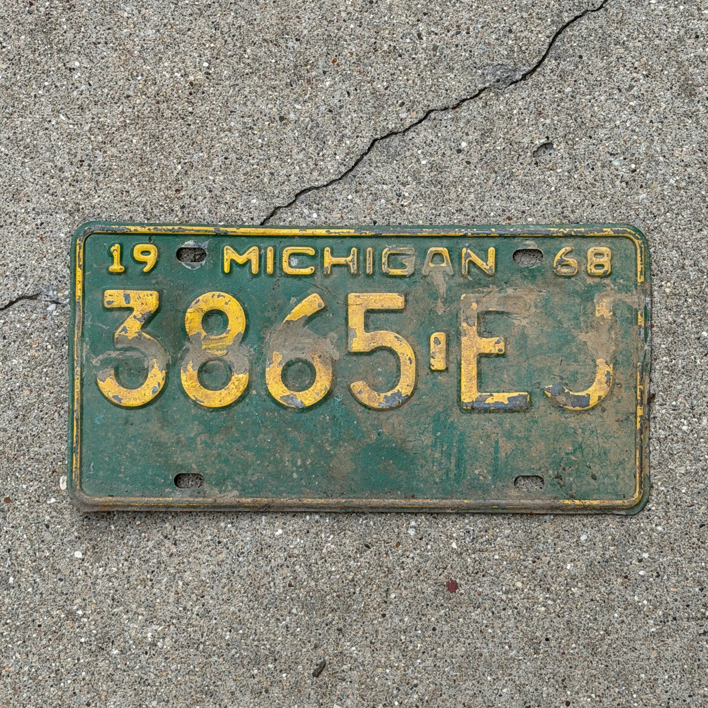 Photo of a 1968 Michigan Commercial License Plate Auto Tag Garage Decor Vintage 3865 EJ with original patina