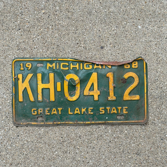 Photo of a 1968 Michigan License Plate Auto Tag Garage Decor Vintage KH 0412 with original patina