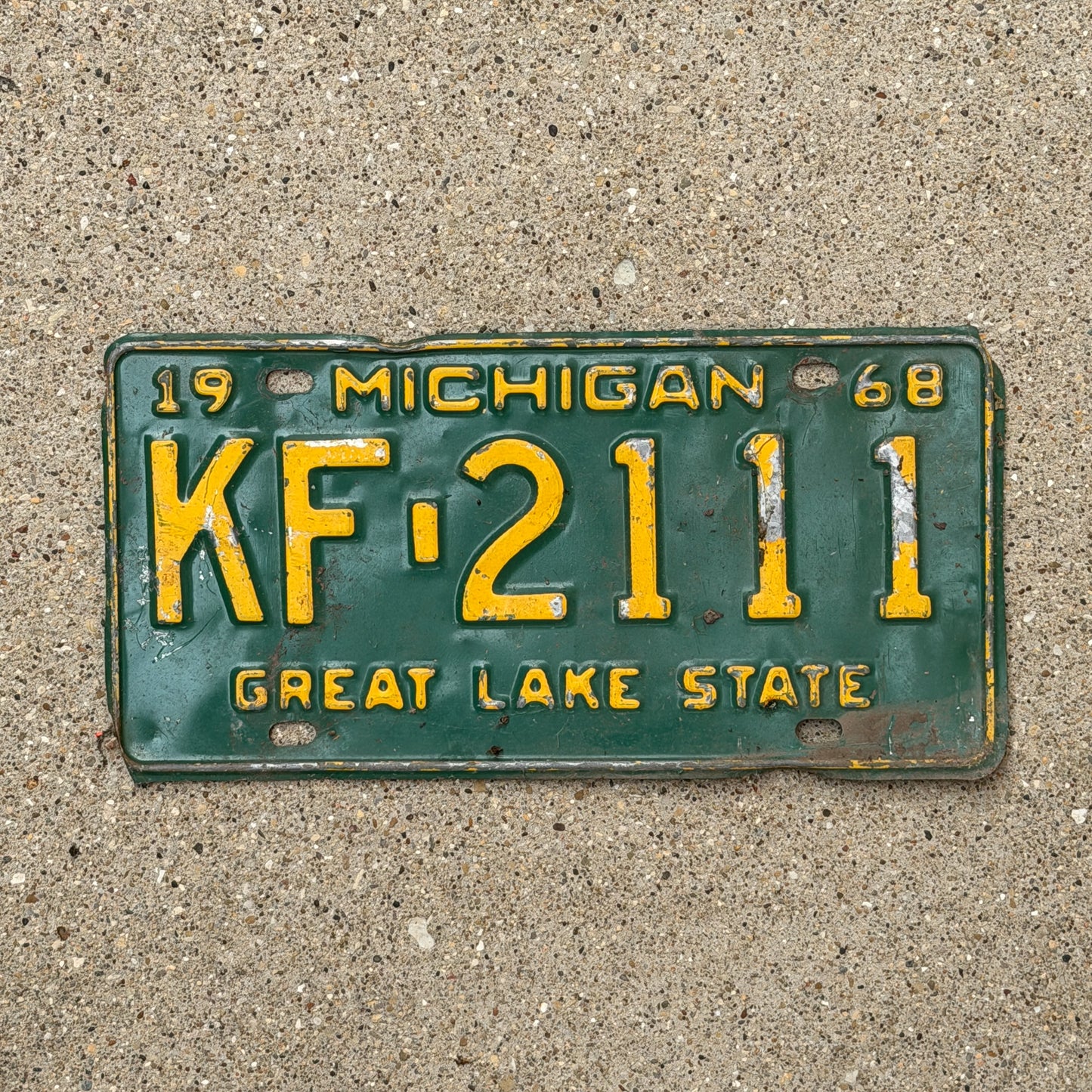 Photo of a 1968 Michigan License Plate Auto Tag Garage Decor Vintage Repeat Repeating KF 2111 with original patina