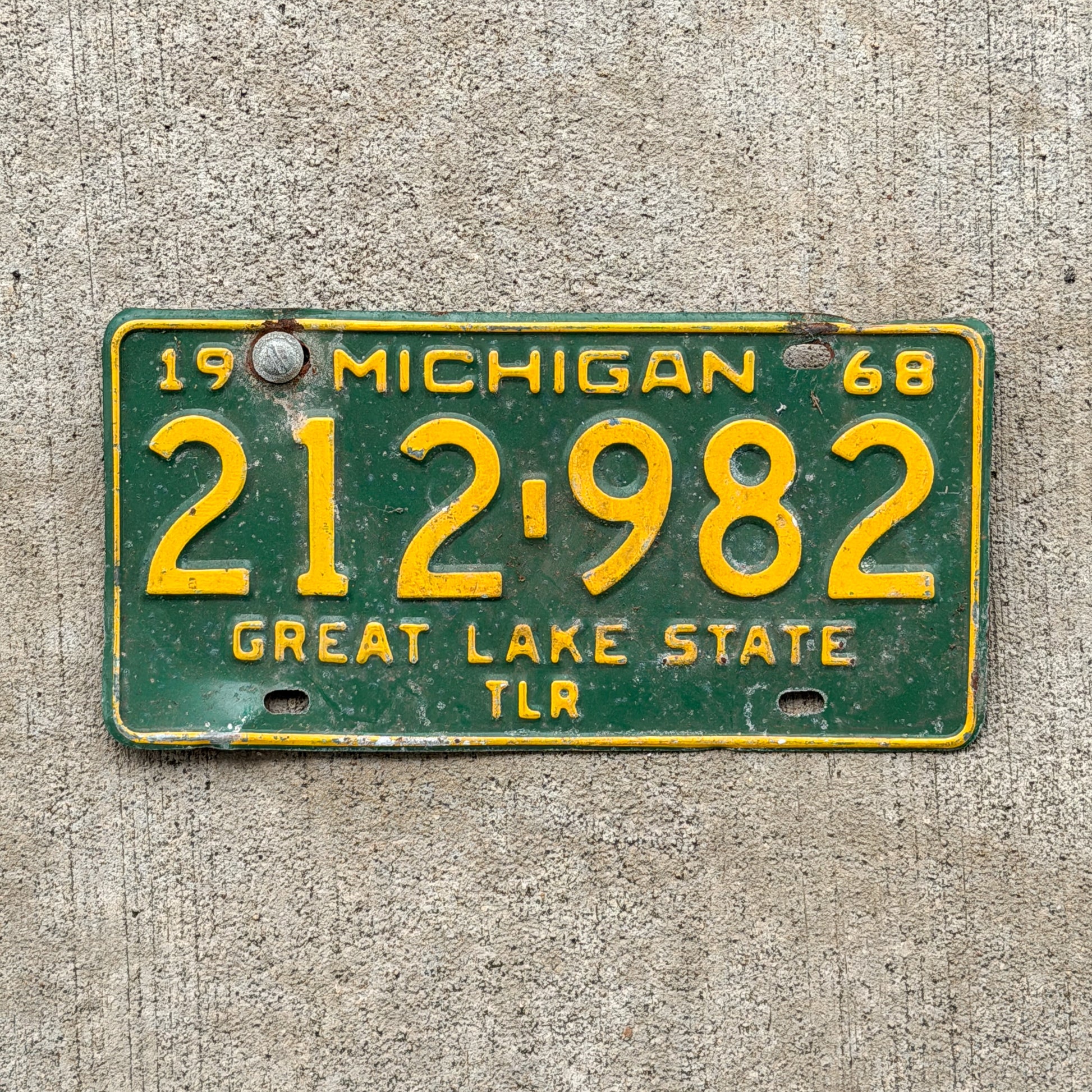 Photo of a 1968 Michigan Trailer License Plate Auto Tag Garage Decor Vintage 212 982 with original patina