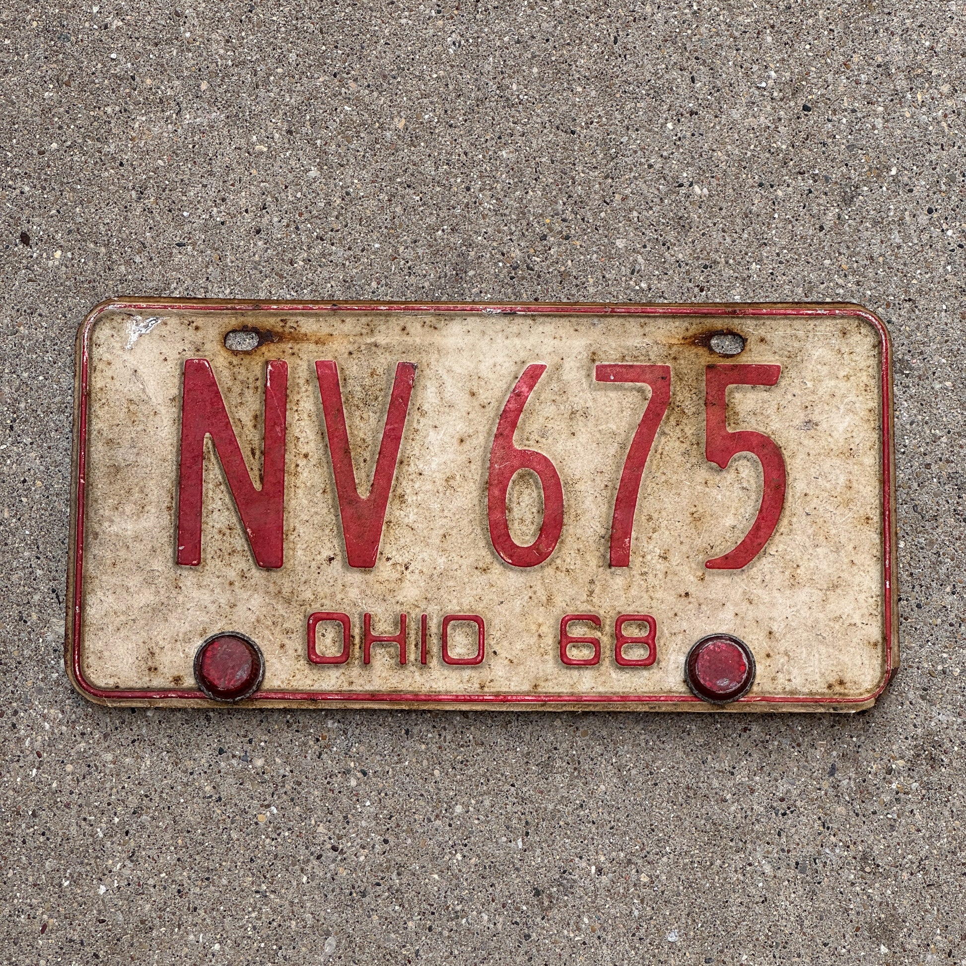 Photo of a 1968 Ohio License Plate Auto Tag 2 Vintage Garage with Red Plastic Reflectors NV 675 with original patina