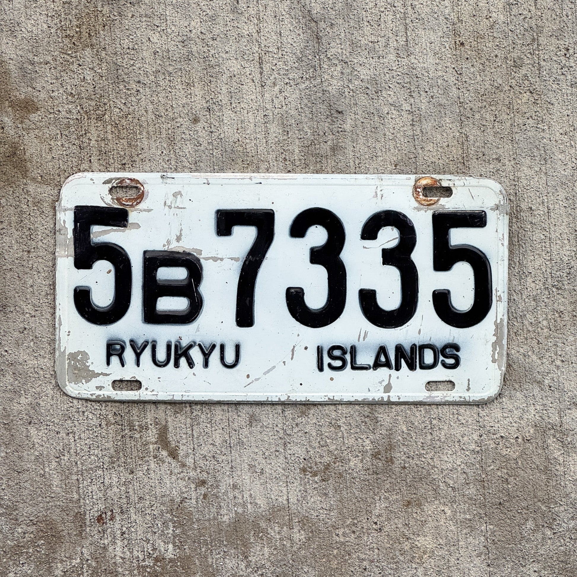 Photo of a 1968 Ryukyu Islands Japan License Plate Auto Tag Garage Decor Vintage Hard to Find 5B 7335 with original patina