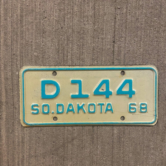 Photo of a 1968 South Dakota Motorcycle Dealer License Plate Auto Tag Garage Decor Vintage D 144 with original patina