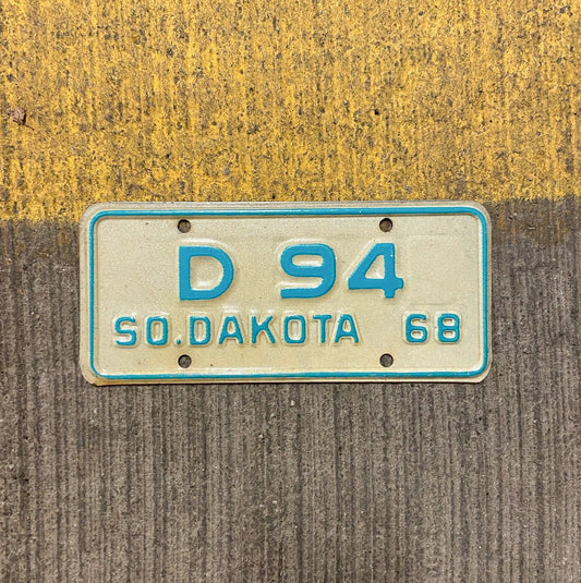 Photo of a 1968 South Dakota Motorcycle Dealer License Plate Auto Tag Garage Decor Vintage Low Number Two Digit D 94 with original patina