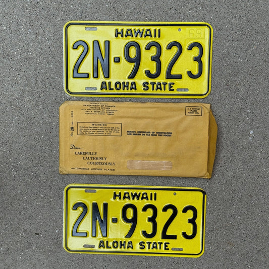 Photo of a 1969 Hawaii License Plate Pair Auto Tag Garage Decor Vintage New Old Stock High Quality With Envelope Honolulu County 2N 9323 with original patina