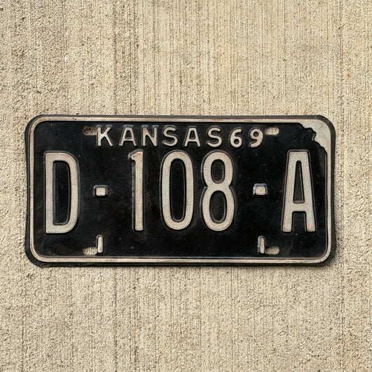 Photo of a 1969 Kansas Dealer License Plate Auto Tag Garage Decor Vintage D 108 A with original patina