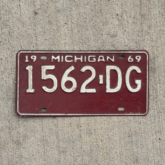 Photo of a 1969 Michigan Commercial License Plate Auto Tag Garage Decor Vintage 1562 DG with original patina
