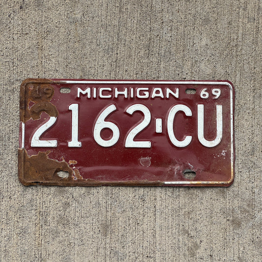 Photo of a 1969 Michigan Commercial License Plate Auto Tag Garage Decor Vintage 2162 CU with original patina