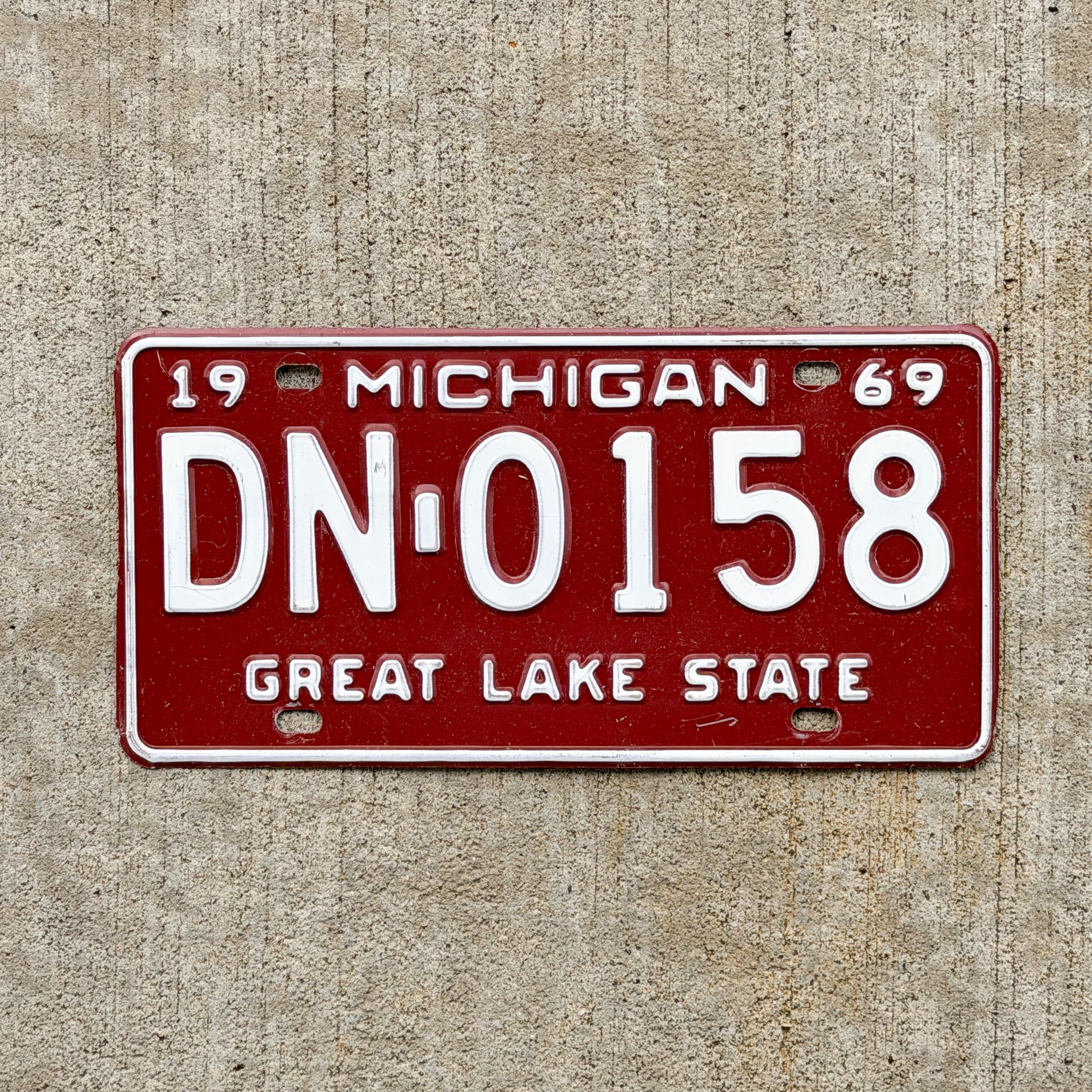 Photo of a 1969 Michigan License Plate Auto Tag Garage Decor Vintage DN 0158 with original patina