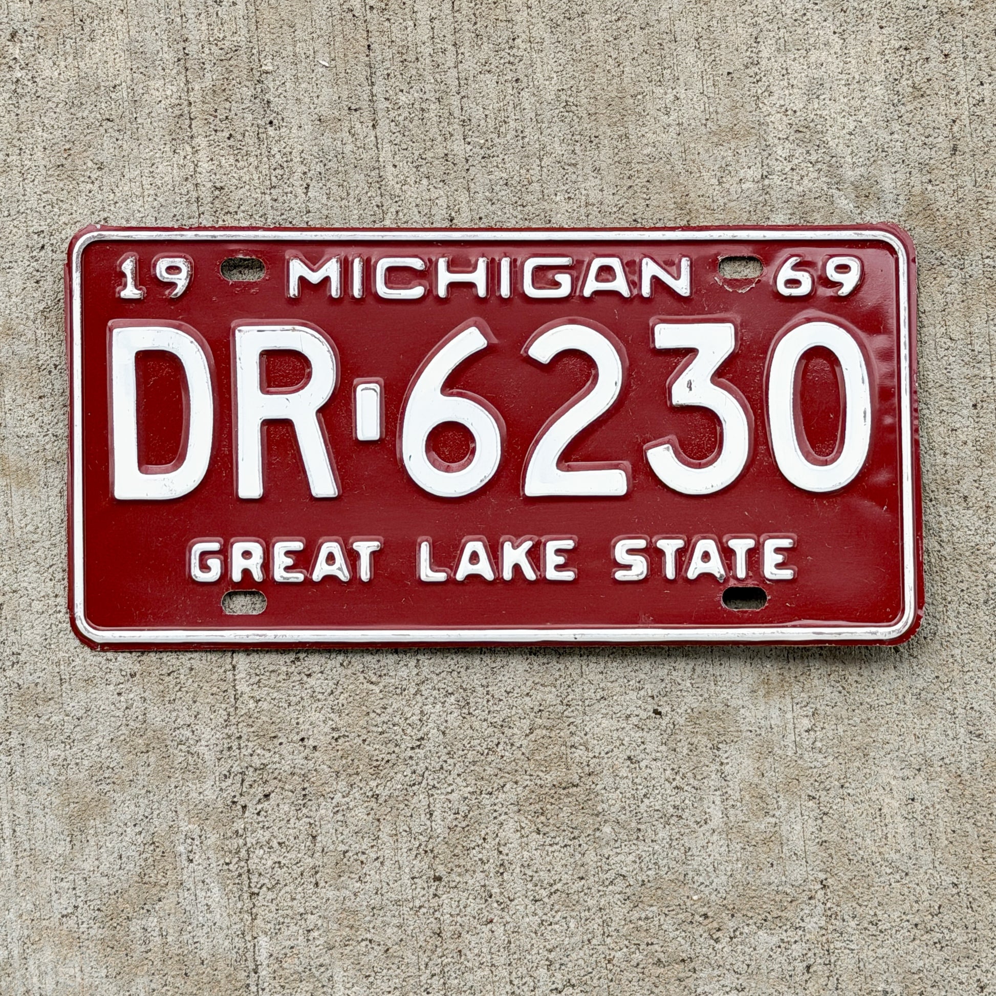 Photo of a 1969 Michigan License Plate Auto Tag Garage Decor Vintage DR 6230 with original patina