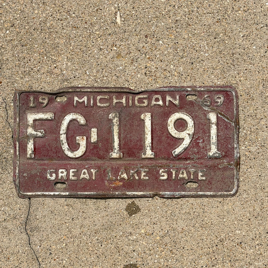 Photo of a 1969 Michigan License Plate Auto Tag Garage Decor Vintage FG 1191 with original patina