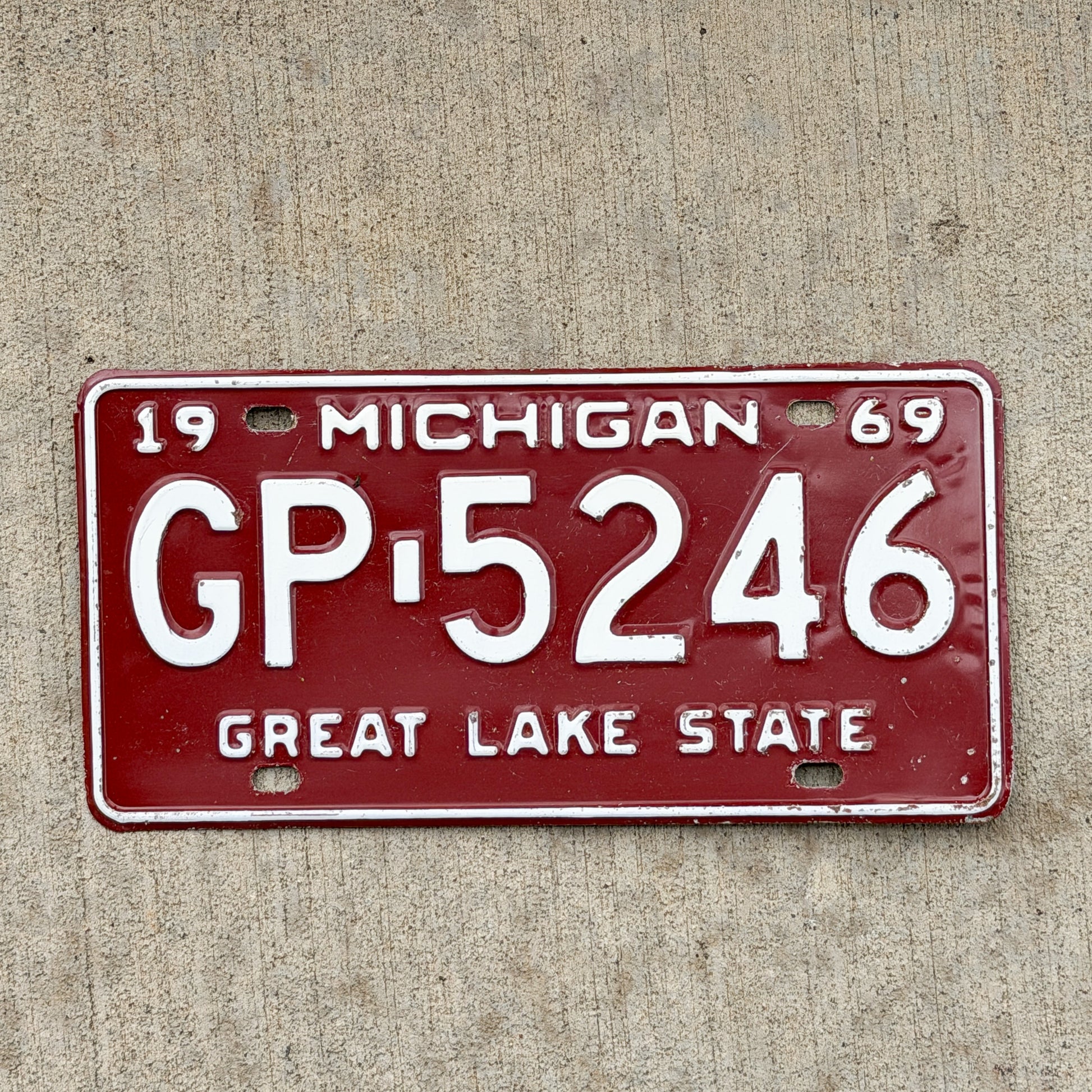 Photo of a 1969 Michigan License Plate Auto Tag Garage Decor Vintage GP 5246 with original patina