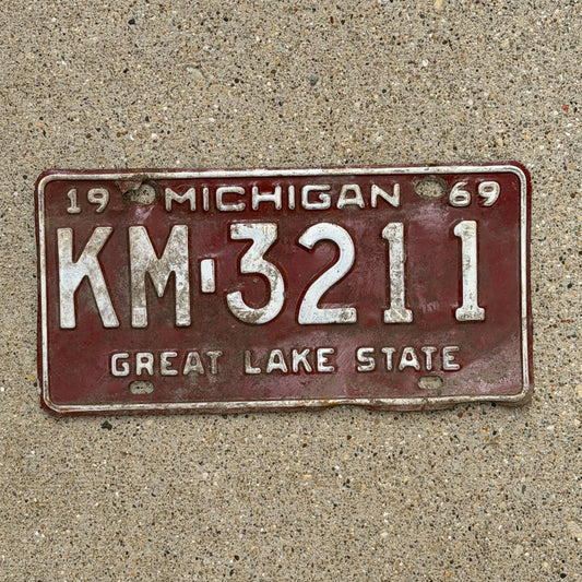 Photo of a 1969 Michigan License Plate Auto Tag Garage Decor Vintage KM 3211 with original patina