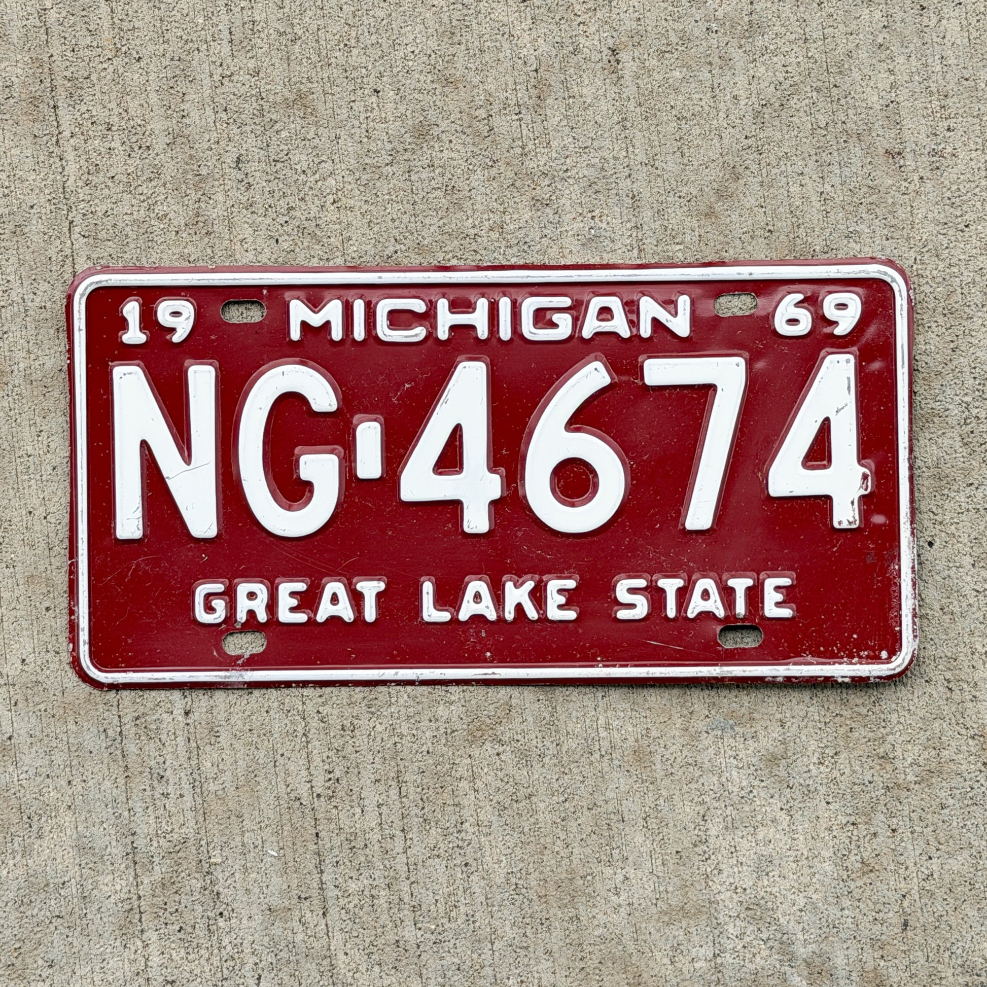 Photo of a 1969 Michigan License Plate Auto Tag Garage Decor Vintage NG 4674 with original patina