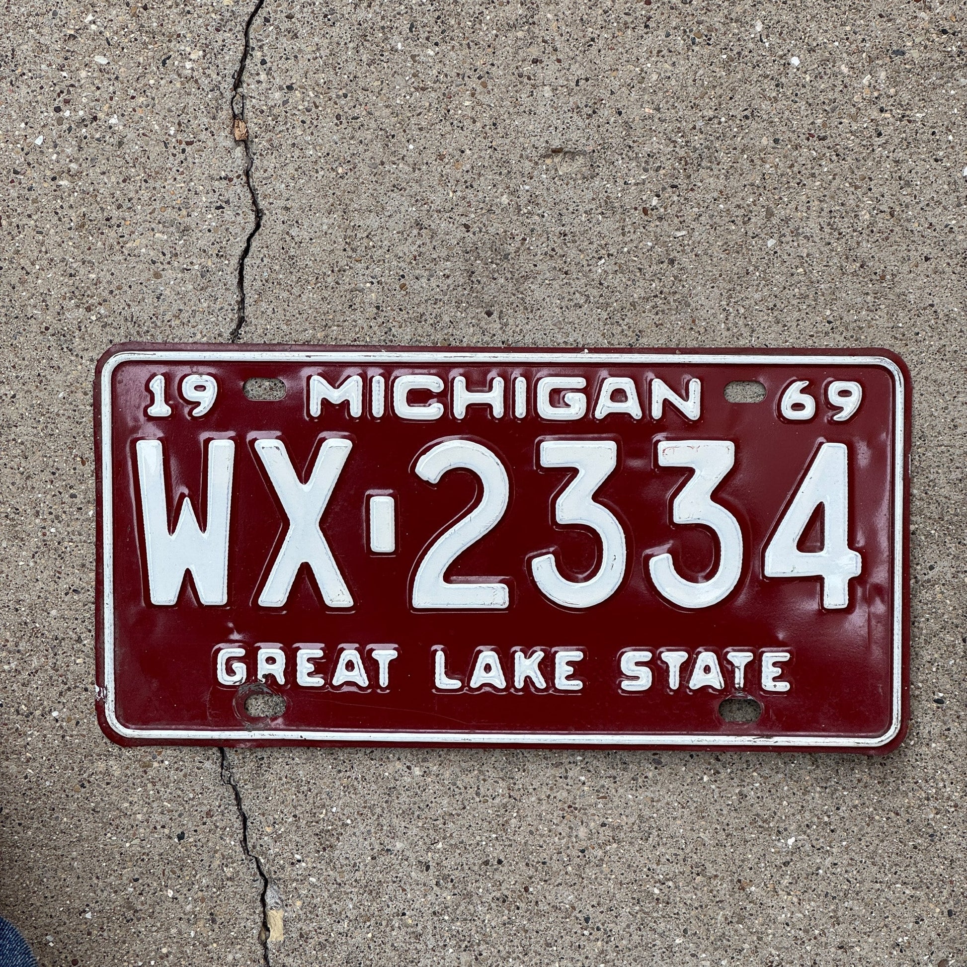 Photo of a 1969 Michigan License Plate Auto Tag Garage Decor Vintage Red White WX 2334