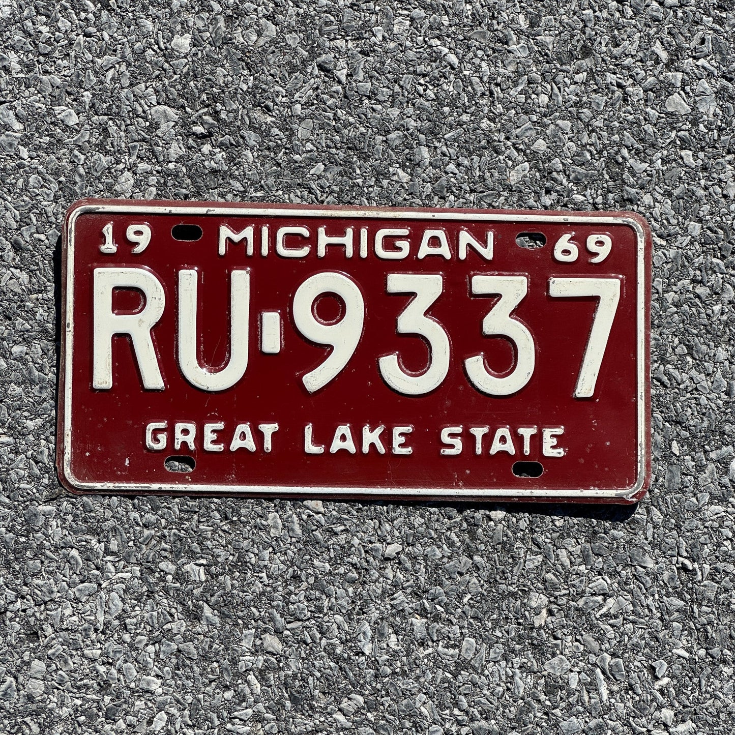 Photo of a 1969 Michigan License Plate Auto Tag Garage Decor Vintage RU 9337