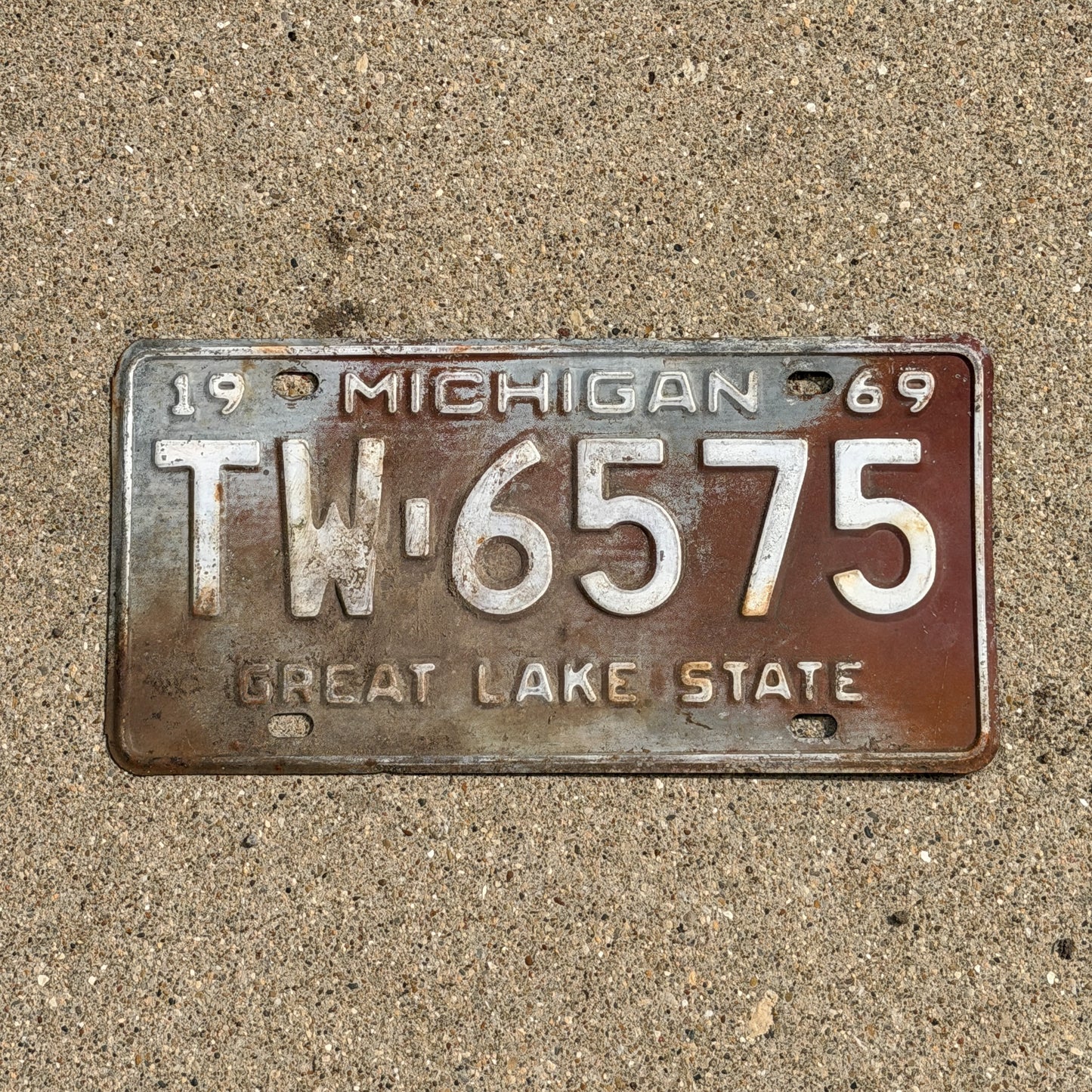 Photo of a 1969 Michigan License Plate Auto Tag Garage Decor Vintage TW 6575 with original patina