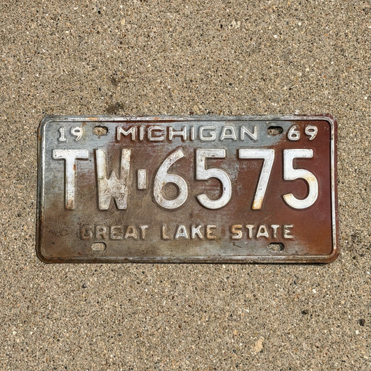 Photo of a 1969 Michigan License Plate Auto Tag Garage Decor Vintage TW 6575 with original patina