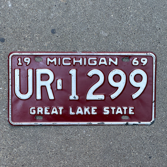 Photo of a 1969 Michigan License Plate Auto Tag Garage Decor Vintage UR 1299 with original patina
