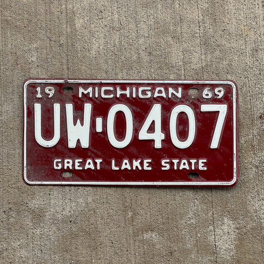 Photo of a 1969 Michigan License Plate Auto Tag Garage Decor Vintage UW 0407 with original patina