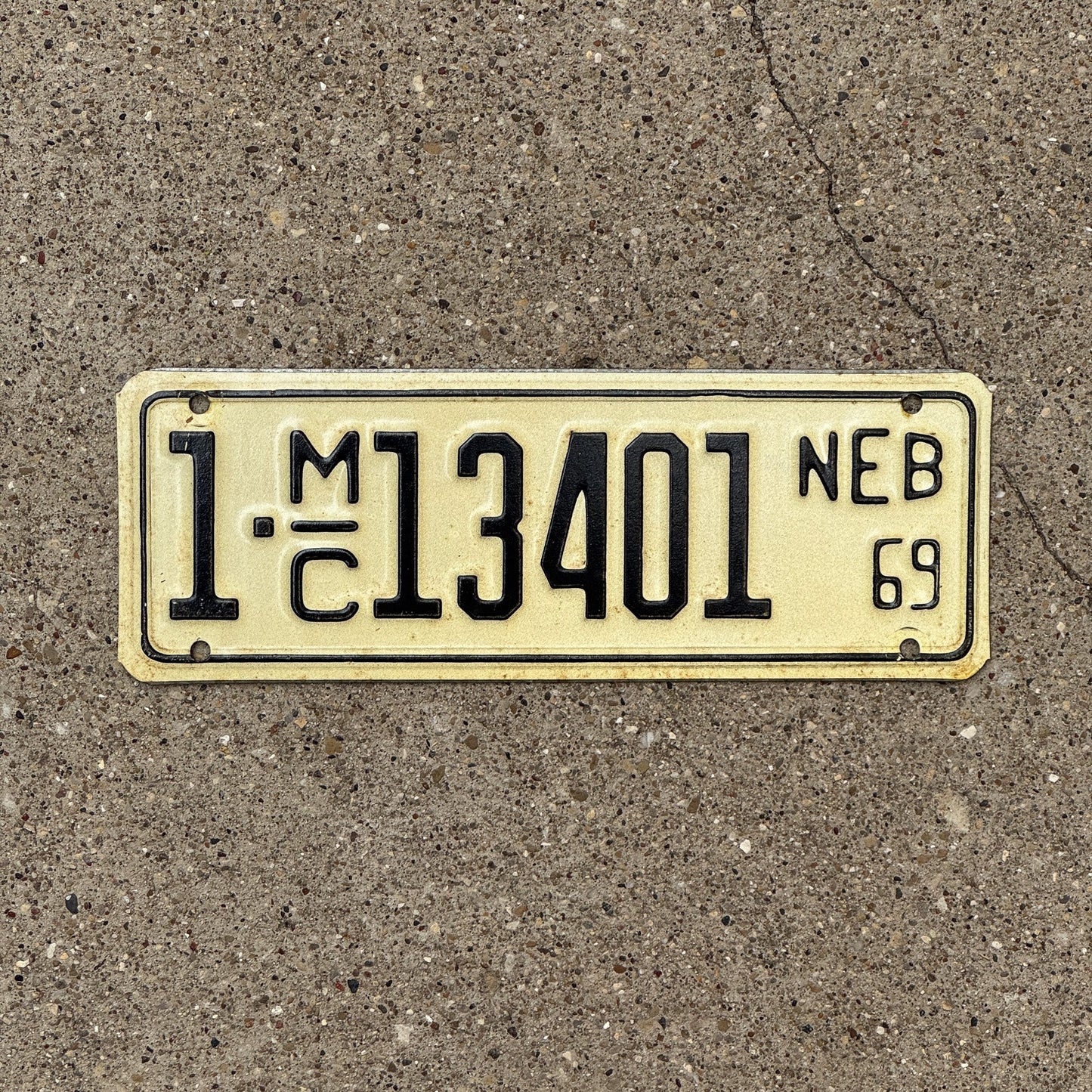 Photo of a 1969 Nebraska Motorcycle License Plate Auto Tag Garage Decor Vintage 1C 13401 with original patina