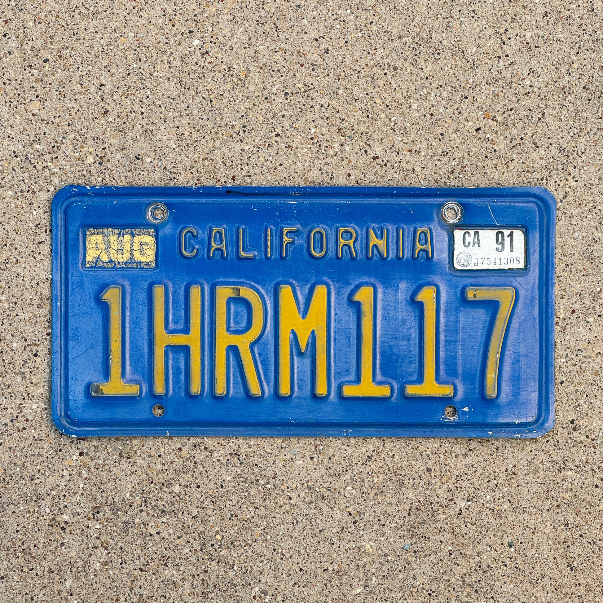 Photo of a 1970 1991 California License Plate Auto Tag Garage Decor Vintage 1 HRM 117 with original patina