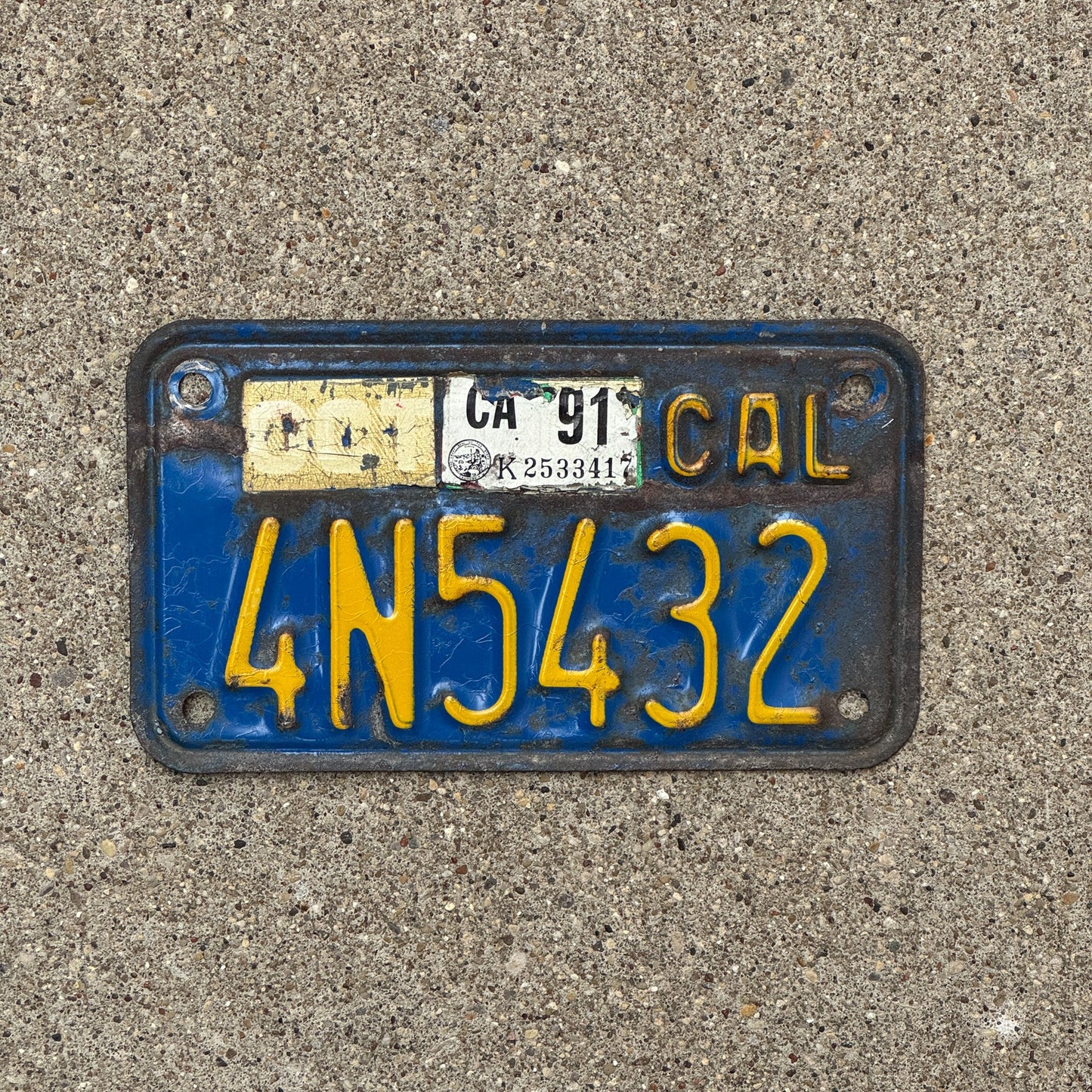 Photo of a 1970 1991 California Motorcycle License Plate Auto Tag Garage Decor Vintage 4N5432 with original patina